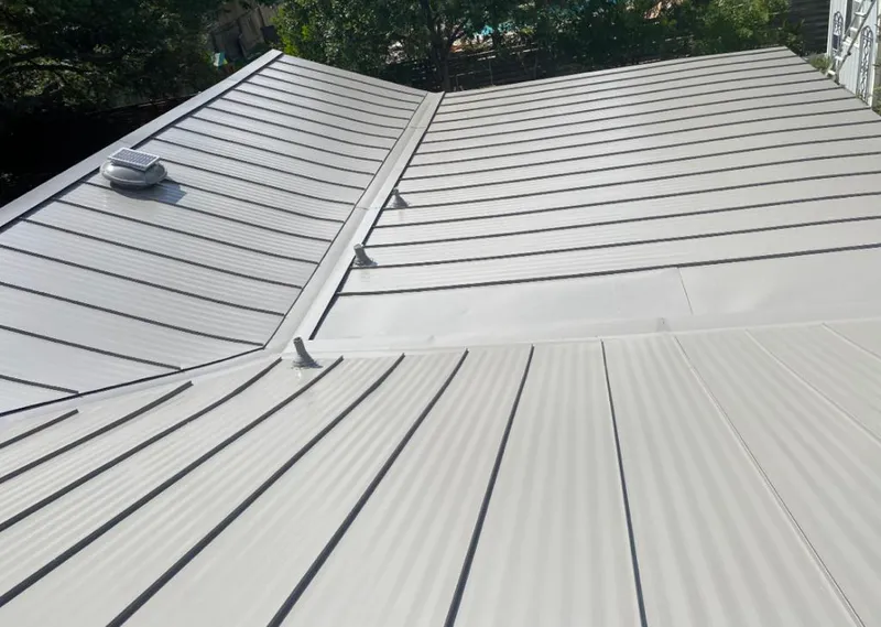 Solar attic fan installed on a metal roof for Roof Ventilation in Wayland